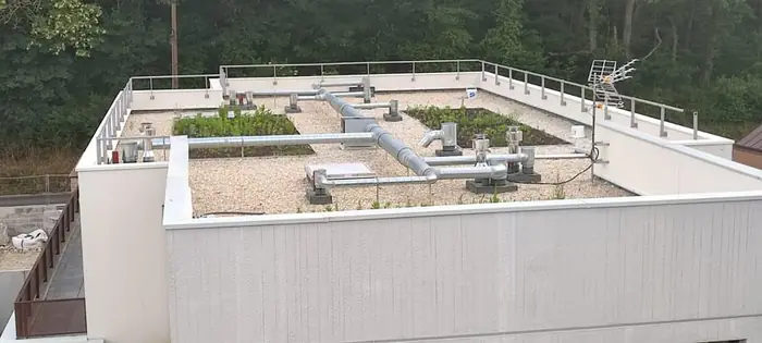 Toiture-terrasse d'un immeuble neuf équipée d'un réseau de VMC collective en gaines galvanisées